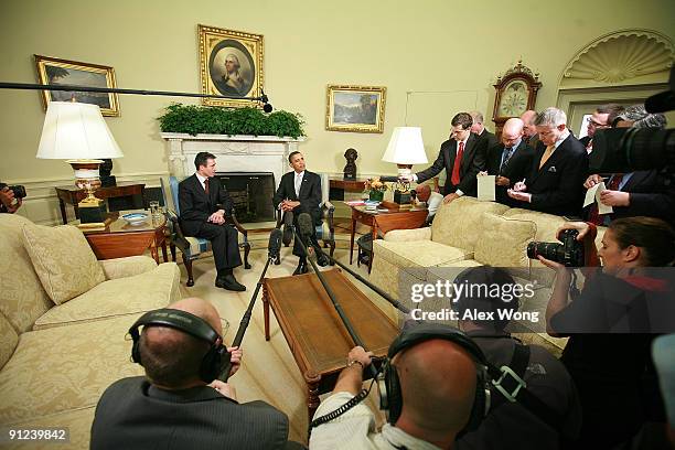 President Barack Obama speaks to the media as NATO Secretary General Anders Fogh Rasmussen looks on in the Oval Office at the White House September...