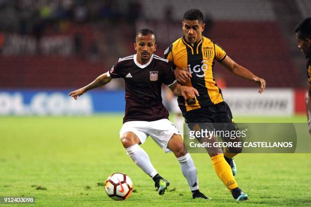 Venezuelan Carabobo's Marlon Fernandez vies for the ball with Paraguayan Guarani's Rodolfo Gamarra during their Copa Libertadores football match at...