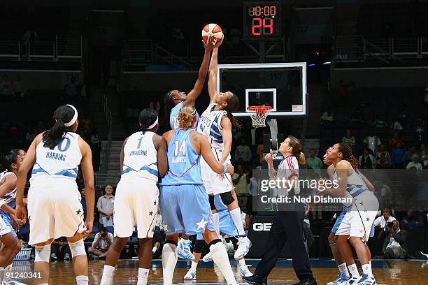 Sancho Lyttle of the Atlanta Dream and Chasity Melvin of the Washington Mystics go after the tip-off during the game at the Verizon Center on...