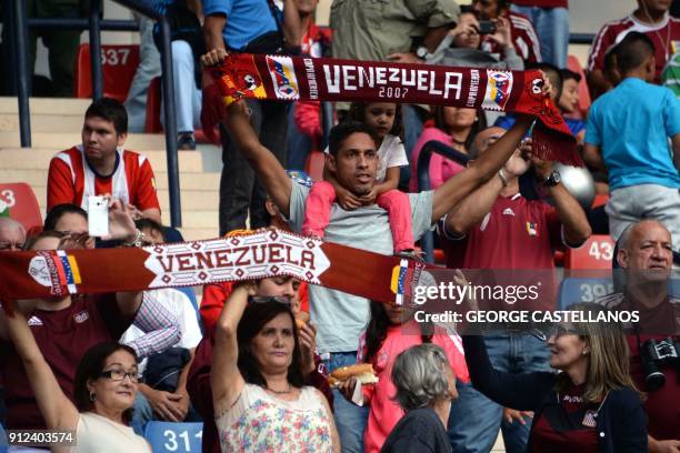 Venezuelan Carabobo's fans cheer for their team during during their Copa Libertadores football match against Paraguayan Guarani's Miguel Benitez at...