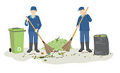 janitor or street cleaners sweeping garbage