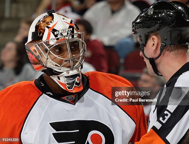 Goaltender Ray Emery of the Philadelphia Flyers talks with referee Kevin Pollock during a break in action against the New Jersey Devils on September...