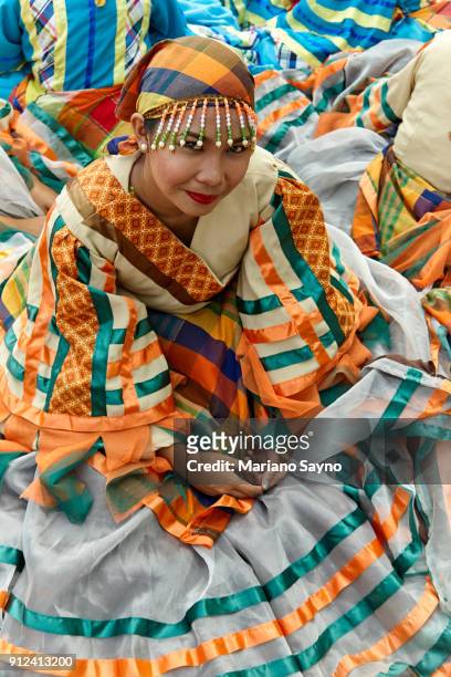 filipina dancer wearing colorful festival costume while sitting - orange bandana stock pictures, royalty-free photos & images