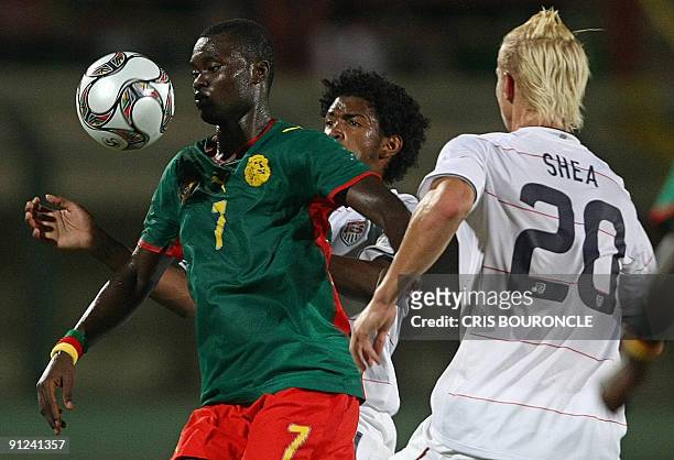 Cameroon's midfielder Olivier Boumale controls the ball as he competes against US playerd Brek Shea and Sheanon Williams during their Group C FIFA...