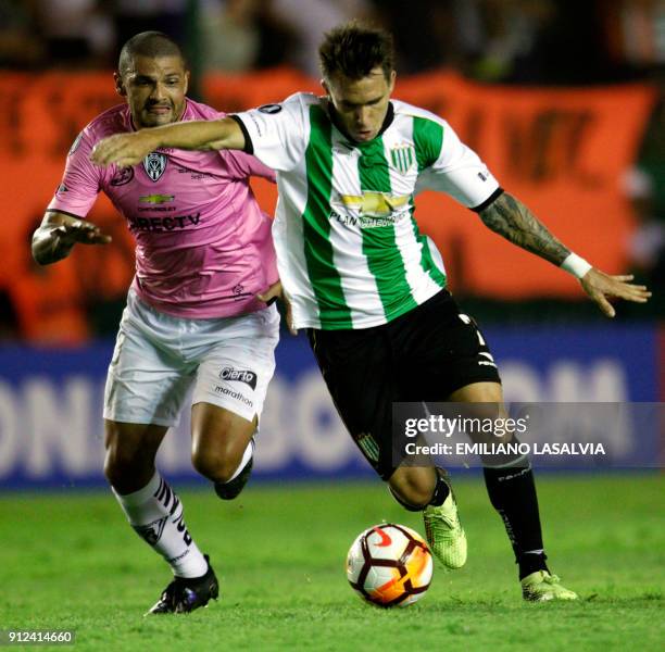 Argentina's Banfield forward Pablo Mouche kicks the ball pressured by Ecuador's Independiente del Valle Juan Segovia Gonzalez, during their Copa...