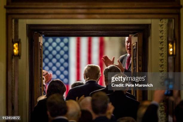 President Donald Trump enters the House of Representatives chamber to deliver his first State of the Union Address before a joint session of Congress...