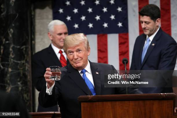 President Donald J. Trump holds a glass of water before he delivers the State of the Union address as U.S. Vice President Mike Pence and Speaker of...