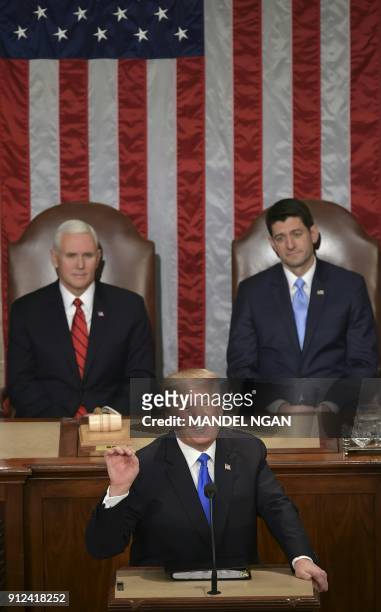 President Donald Trump delivers the State of the Union address as US Vice President Mike Pence and Speaker of the House Paul Ryan listen at the US...