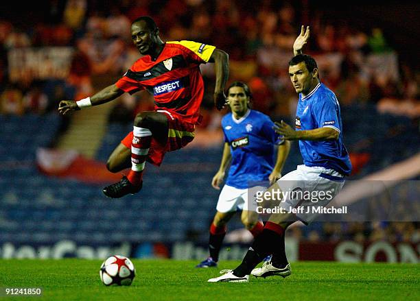 Lee McCulloch of Rangers tackles Didier Zokora of Sevilla during the UEFA Champions League Group G match between Rangers and Sevilla at Ibrox Stadium...
