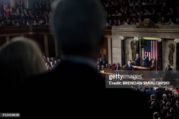 President Donald Trump gestures while US Vice President Mike Pence and Speaker of the House Paul Ryan clap for him during the State of the Union...