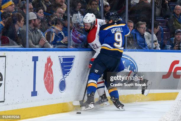 Scottie Upshall of the St. Louis Blues checks David Schlemko of the Montreal Canadiens at Scottrade Center on January 30, 2018 in St. Louis, Missouri.