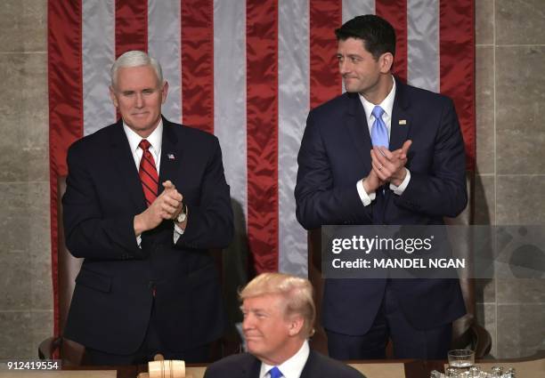 Vice President Mike Pence and Speaker of the House Paul Ryan clap as US President Donald Trump gives his State of the Union address in the House...