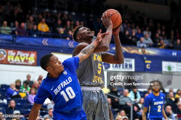 Kent State Golden Flashes forward Danny Pippen is fouled in the act of shooting by Buffalo Bulls guard Wes Clark during the second half of the men's...