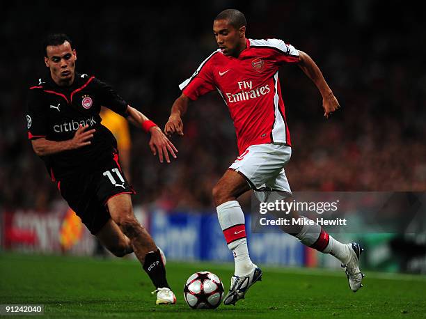 Gael Clichy of Arsenal runs with the ball as Jaouad Zairi of Olympiakos defends during the UEFA Champions League Group H match between Arsenal and...