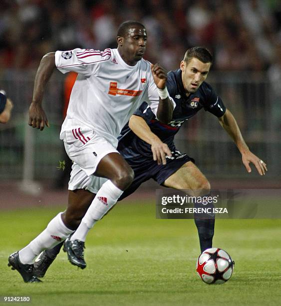 Anthony Reveillere of Olympic Lyon and Adamo Coulibaly of Hungarian VSC Debrecen battle for the ball during the UEFA Champions League match in...