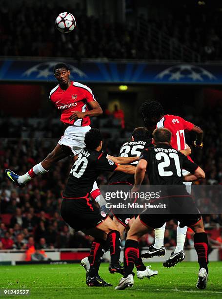 Abou Diaby of Arsenal heads the ball during the UEFA Champions League Group H match between Arsenal and Olympiakos at the Emirates Stadium on...