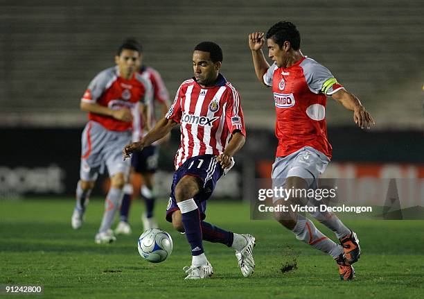 Maykel Galindo of Chivas USA plays the ball away from Patricio Araujo of Chivas de Guadalajara during the International Club Friendly at the Rose...