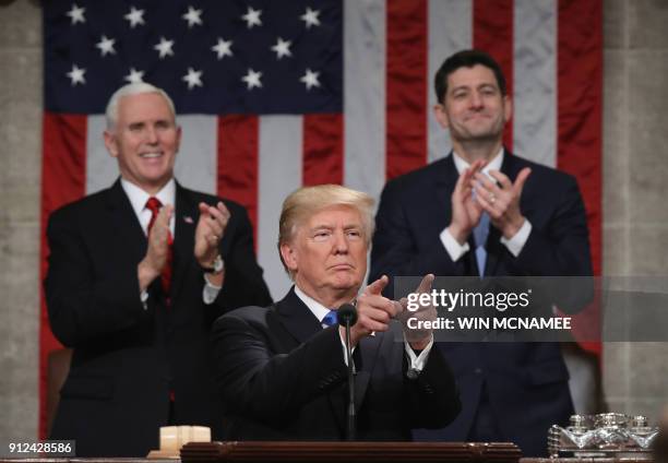 President Donald Trump delivers the State of the Union address as US Vice President Mike Pence and Speaker of the House US Rep. Paul Ryan clap in the...