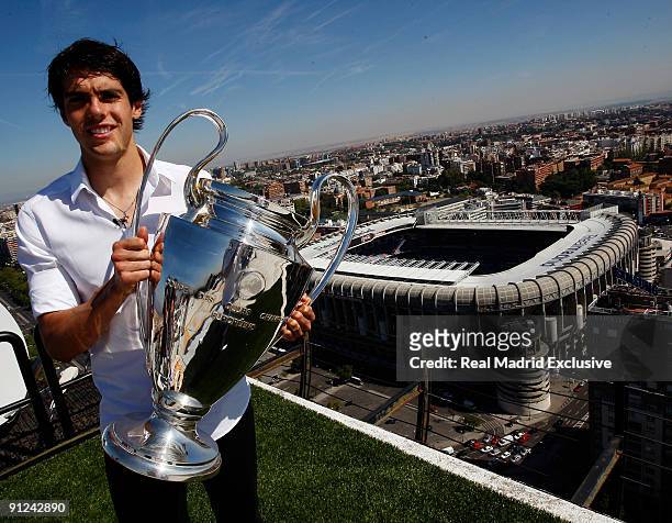 Kaka of Real Madrid poses with a European Cup and the Santiago Bernabeu Stadium during a interview at Torre Europa on September 29, 2009 in Madrid,...