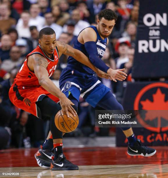 Toronto Raptors forward Norman Powell looks to regain control of the ball when being defended by Minnesota Timberwolves guard Tyus Jones . Toronto...