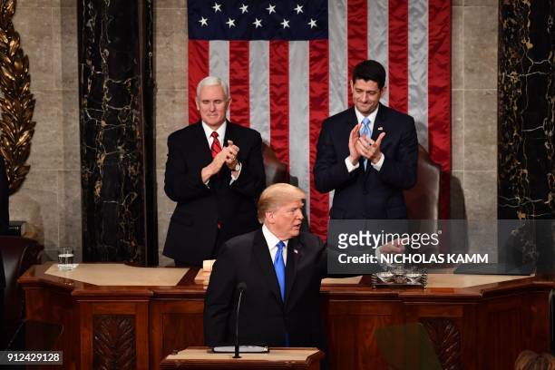 Vice President Mike Pence and Speaker of the US House of Representatives Paul Ryan applaud US President Donald Trump before the State of the Union...