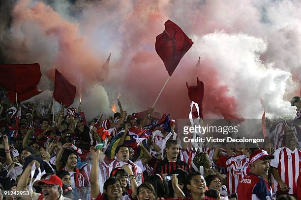 Fans of Chivas de Guadalajara celebrate a goal with smoke bombs and fireworks in the second half during the International Club Friendly match between...
