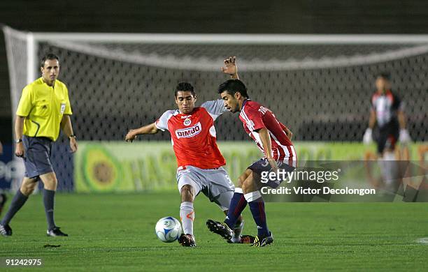 Paulo Nagamura of Chivas USA passes the ball as Patricio Araujo of Chivas de Guadalajara defends the play during the International Club Friendly at...
