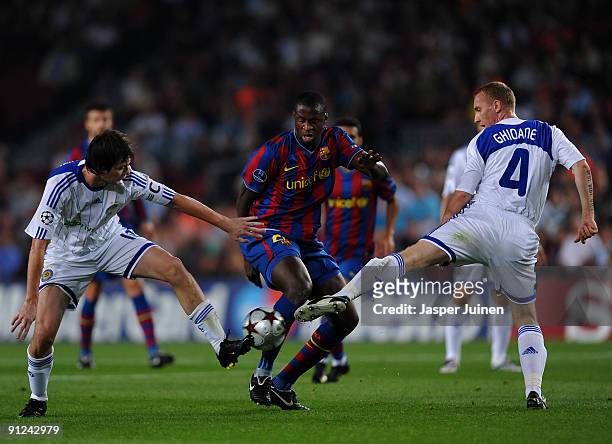 Yaya Toure of Barcelona duels for the ball with Artem Milevskiy and Tiberiu Ghioane of Dynamo Kiev during the Champions League group F match between...