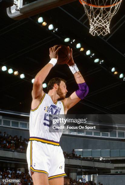 Mark Eaton of the Utah Jazz battles grabs a rebound against the Phoenix Suns during an NBA basketball game circa 1989 at the Salt Palace in Salt Lake...