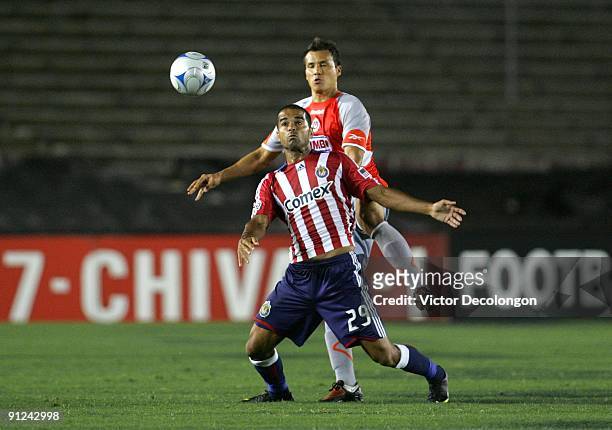 Maicon Santos of Chivas USA plays the ball in front of Aaron Galindo of Chivas de Guadalajara during the International Club Friendly at the Rose Bowl...
