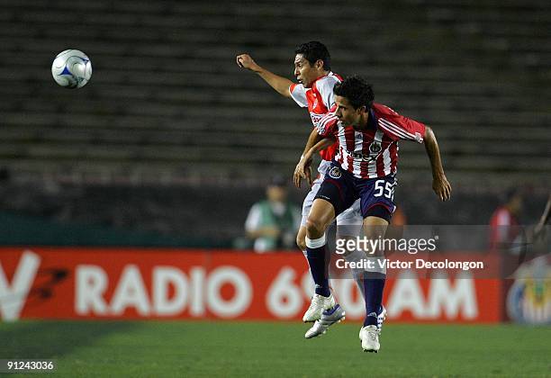 Marcelo Saragosa of Chivas USA and Ramon Morales of Chivas de Guadalajara vie for a high ball during the International Club Friendly at the Rose Bowl...
