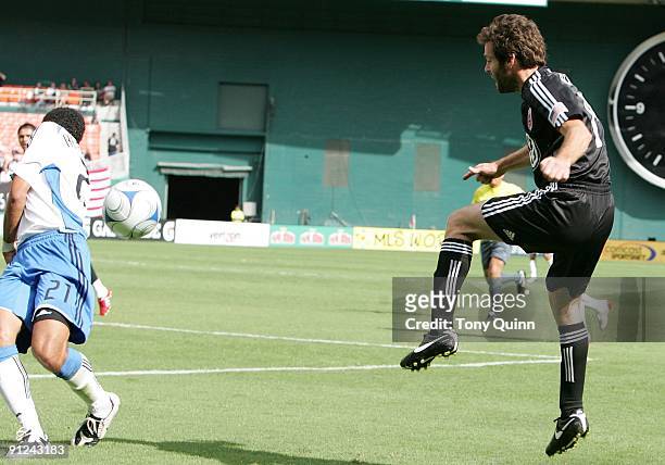 Ben Olsen of D.C. United blasts the ball off the back of Jason Hernandez of the San Jose Earthquakes during an MLS match at RFK Stadium on September...