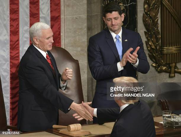 President Donald Trump shakes hands with US Vice President Mike Pence and Speaker of the House Paul Ryan following his State of the Union address at...