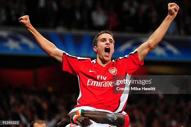 Robin van Persie of Arsenal celebrates after he scored the first goal during the UEFA Champions League Group H match between Arsenal and Olympiakos...