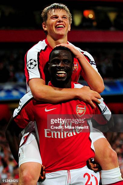 Andrey Arshavin of Arsenal celebrates with his team mate Emmanuel Eboue after Arshavin scored the second goal during the UEFA Champions League Group...