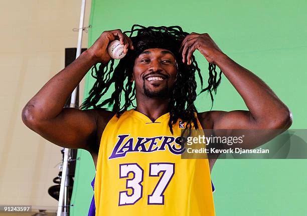 Ron Artest of the Los Angeles Lakers wears a wig to resemble baseball player Manny Ramirez while taping a public announcement for the Los Angeles...