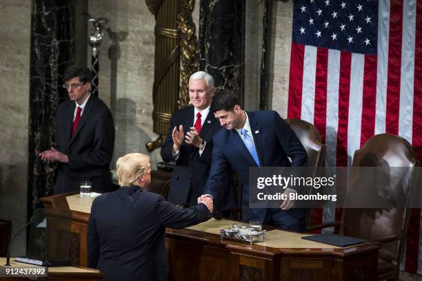 President Donald Trump, bottom, greets U.S. House Speaker Paul Ryan, a Republican from Wisconsin, right, after delivering a State of the Union...