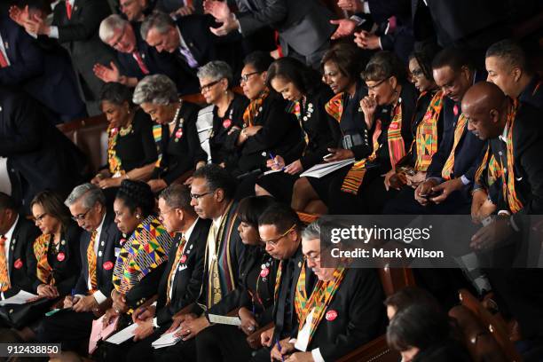 Members of Congress wear black clothing and Kente cloth in protest before the State of the Union address in the chamber of the U.S. House of...