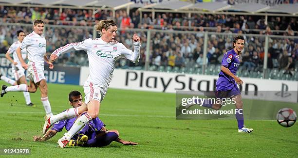 Fernando Torres of Liverpool is challenged in the penalty area by Alessandro Gamberini of Fiorentina during the UEFA Champions League group E match...