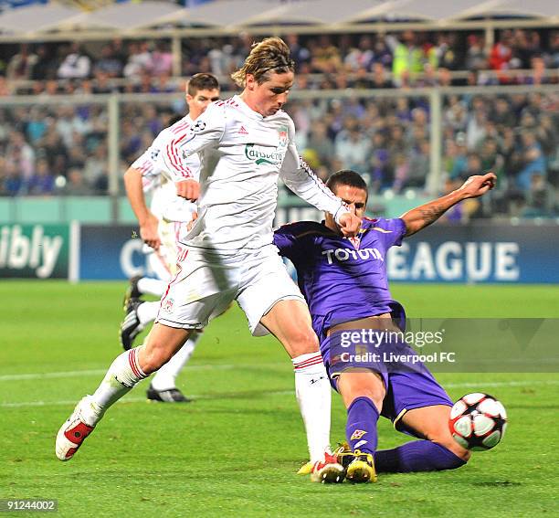 Fernando Torres of Liverpool is challenged in the penalty area by Alessandro Gamberini of Fiorentina during the UEFA Champions League group E match...