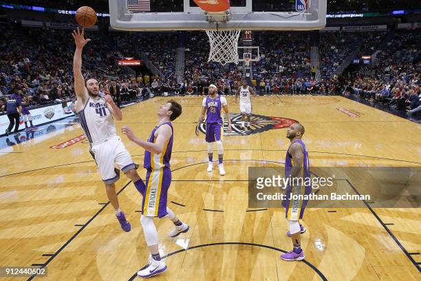 Kosta Koufos of the Sacramento Kings shoots against Omer Asik of the New Orleans Pelicans during the second half at the Smoothie King Center on...