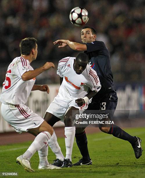 Olympique Lyonnais' French defender Anthony Reveillere vies with VSC Debrecen's French forward Adamo Coulibaly during the UEFA Champions League...