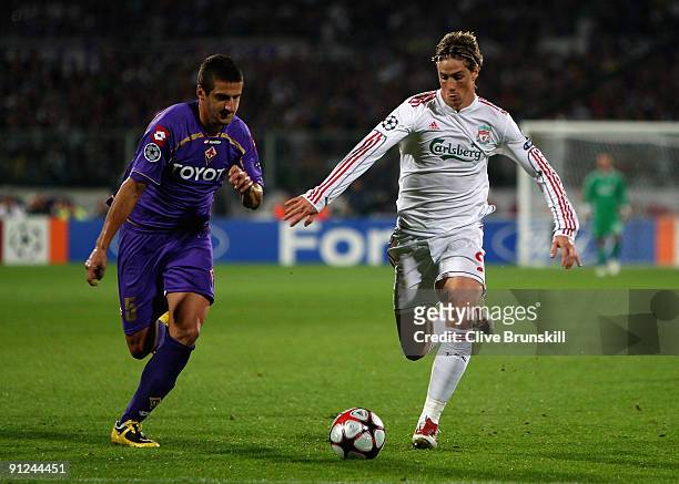 Fernando Torres of Liverpool in action with Alessandro Gamberini of Fiorentina during the UEFA Champions League Group E match between Fiorentina and...