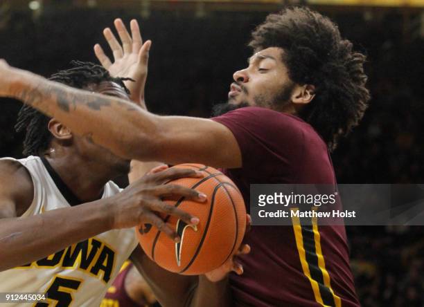 Forward Jordan Murphy of the Minnesota Gophers defends against forward Tyler Cook of the Iowa Hawkeyes in the first half of their match-up on January...