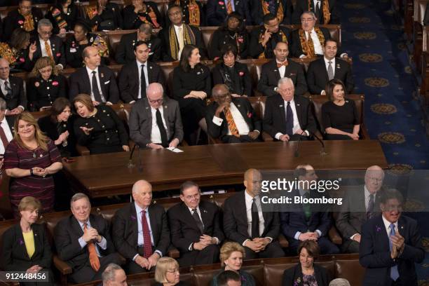 Senator Joe Manchin, a Democrat from West Virginia, stands and claps as his fellow democrats stay seated while U.S. President Donald Trump, not...