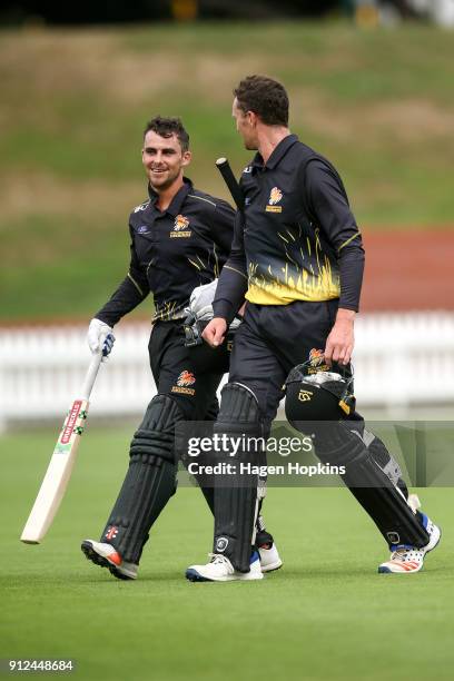 Peter Younghusband and Ollie Newton of the Firebirds leave the field after winning the Ford Trophy match between the Wellington Firebirds and the...