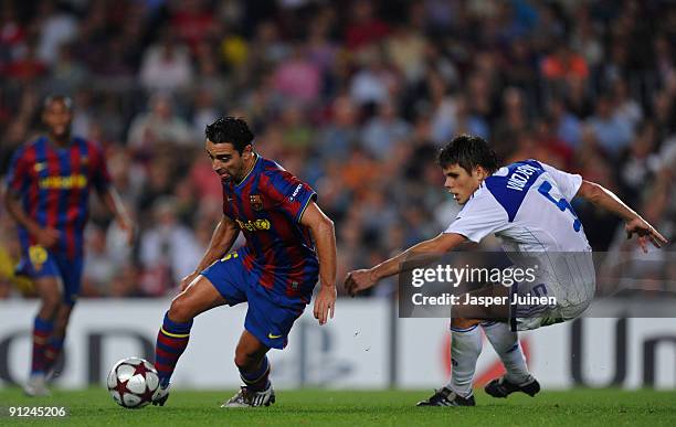 Xavier Hernandez of Barcelona duels for the ball with Ognjen Vukojevic of Dynamo Kiev during the Champions League group F match between Barcelona and...