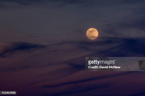 The Moon rises over the Mojave Desert before becoming a so-called "super blue blood moon" when it becomes totally eclipsed before dawn, on January...