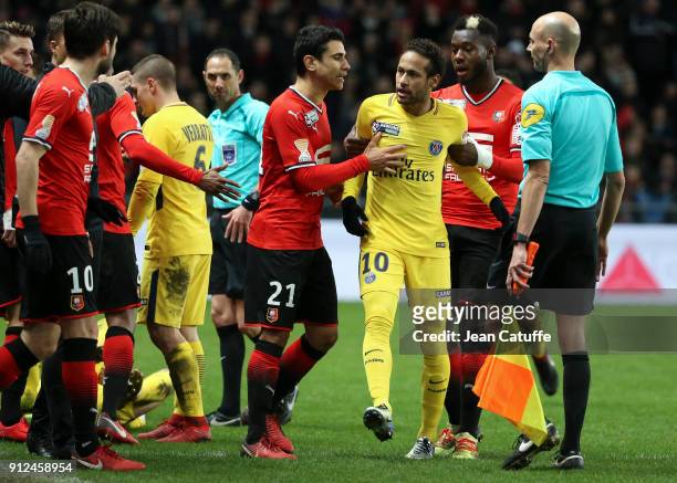 Neymar Jr of PSG, upset, is restrained by Benjamin Andre and Joris Gnagnon of Stade Rennais during the French League Cup match between Stade Rennais...