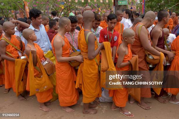 Cambodia Buddhist monks line up to get alms during the Meak Bochea Buddhist celebration at the Oddong mountain in Kandal province, some 40 kilometers...